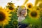 Beautiful smiling woman in the field with sunflowers