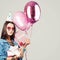 Beautiful smiling woman with gift, candy, birthday cap