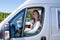 Beautiful smiling woman in RV camper van during travel motor home camping car in vanlife