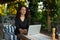 Beautiful Smiling Woman Typing On Notebook Working Online Using Laptop Computer. Female Sitting On Terrace Balcony