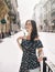 Beautiful smiling woman walking on crowded city street.