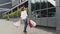 Beautiful smiling woman walking on the street. Attractive young woman walking happily downtown with shopping bags. A