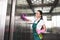 beautiful smiling young cleaner washing elevator with detergent