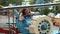 Beautiful smiling young girl in sunglasses riding a childrens carousel. Close view. Slow motion