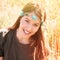 Beautiful smiling young woman boho portrait with head band with flowers in summer meadow