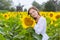 Beautiful smiling young woman in a white shirt stands in the fie