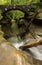 Beautiful smooth flowing stream under a stone bridge at Hocking Hills State Park, Ohio.