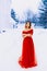 Beautiful snow maiden girl with red hair on february nature. Snow fall in february. Long retro gown