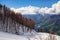 Beautiful snowy Aibga mountain ski slope on cloudy blue sky background at spring dramatic scenic landscape.