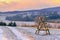 Beautiful snowy winter landscape with hunters perch stand within sunset