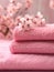 A beautiful, soft stack of pink towels bathed in natural light