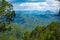 A beautiful and soothing landscape of mountains covered in clouds and green trees during winters