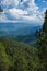 A beautiful and soothing landscape of mountains covered in clouds and green trees during winters