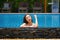 Beautiful southeast asia woman in pool relaxing.