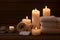 Beautiful spa setting with bathrobe, slippers, candles, cosmetics. Beauty wellness center treatment and relax concept.