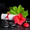 Beautiful spa still life of red hibiscus flower with dew, candle