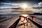 Beautiful spectacles on wooden bridge extended into the sea near