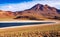 Beautiful spectacular colorful andes high plains landscape, dark blue lonely quiet calm lake lagoon, rugged mountains, arid ground