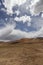 A beautiful and spectacular snow mountain and golden alpine meadow under the dark cloud sky