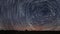 Beautiful Spiral Star Trails over filed with lonely tree. Beautiful night sky.