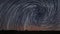 Beautiful Spiral Star Trails over filed with lonely tree. Beautiful night sky.