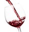 Beautiful splash of red wine in a glass on white background