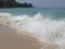 Beautiful splashes of waves on the beach of the sea coast on a bright Sunny day