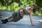 Beautiful sport woman training one arm pushup in p