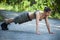 Beautiful sport woman training push-ups in park