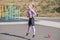 Beautiful and sportive blonde girl doing jumps on the street sports ground.