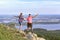 A beautiful sports mature couple stands on the top of the sugomak mountain against the background of the city of Kyshtym and admir