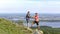 A beautiful sports mature couple stands on the top of the sugomak mountain against the background of the city of Kyshtym and admir