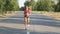 Beautiful sportswoman running on a country road. Training outdoors