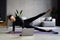 Beautiful sporty cheerful woman is doing side plank exercise watching video on the internet and repeating the tasks