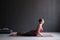 Beautiful sporty fit yogini woman practices yoga asana bhujangasana