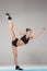 Beautiful sporty girl standing in acrobat pose or yoga asana