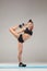 Beautiful sporty girl standing in acrobat pose or yoga asana