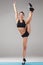 Beautiful sporty girl standing in acrobat pose or yoga asana