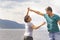 Beautiful sporty mature couple dancing on the beach on the Volga river against the background of the Zhiguli mountains