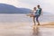 Beautiful sporty mature couple dancing on the beach on the Volga river against the background of the Zhiguli mountains