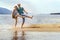 Beautiful sporty mature couple dancing on the beach on the Volga river against the background of the Zhiguli mountains