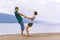 Beautiful sporty mature couple dancing on the beach on the Volga river against the background of the Zhiguli mountains