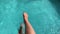 Beautiful sporty slim woman legs relaxing in water swimming pool spa, Enjoying suntan summer time, Female splashing feet