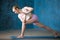 Beautiful sporty young woman doing Revolved Side Angle Pose