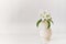 A beautiful a sprig of apple tree with white flowers in a wood vase