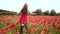 Beautiful spring girl run in poppy field. Beauty young woman on poppies background, spring blossom flowering meadow