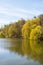 Beautiful spring lake and forest. Springtime season Abstract natural background. Blurry silhouettes of many green spring
