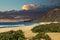 a beautiful spring landscape at Sandy Beach with blue ocean water, silky brown sand, people relaxing, palm trees