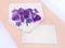 Beautiful spring snowdrops flowers violet crocuses and blue flowers hepatica in postal envelope and blank sheet