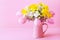 Beautiful spring still life with colorful flowers in pink vase. Mothers or Woman day greeting card